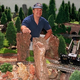 Model-train addict Leon Gehr poses with his stash.